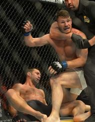 INGLEWOOD, CA - JUNE 04: Referee Big John McCarthy pulls Michael Bisping (blue gloves) off of opponent Luke Rockhold (red gloves) after knocking him out to win their Middleweight Title Bout at UFC 199 at The Forum on June 4, 2016 in Inglewood, California. (Photo by Jayne Kamin-Oncea/Getty Images)